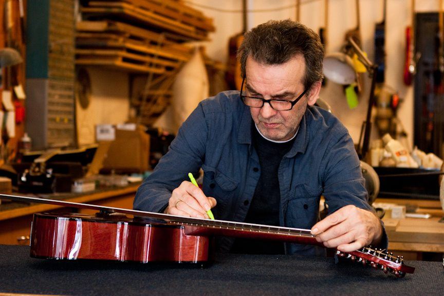 Danche working on a guitar at his repair bench