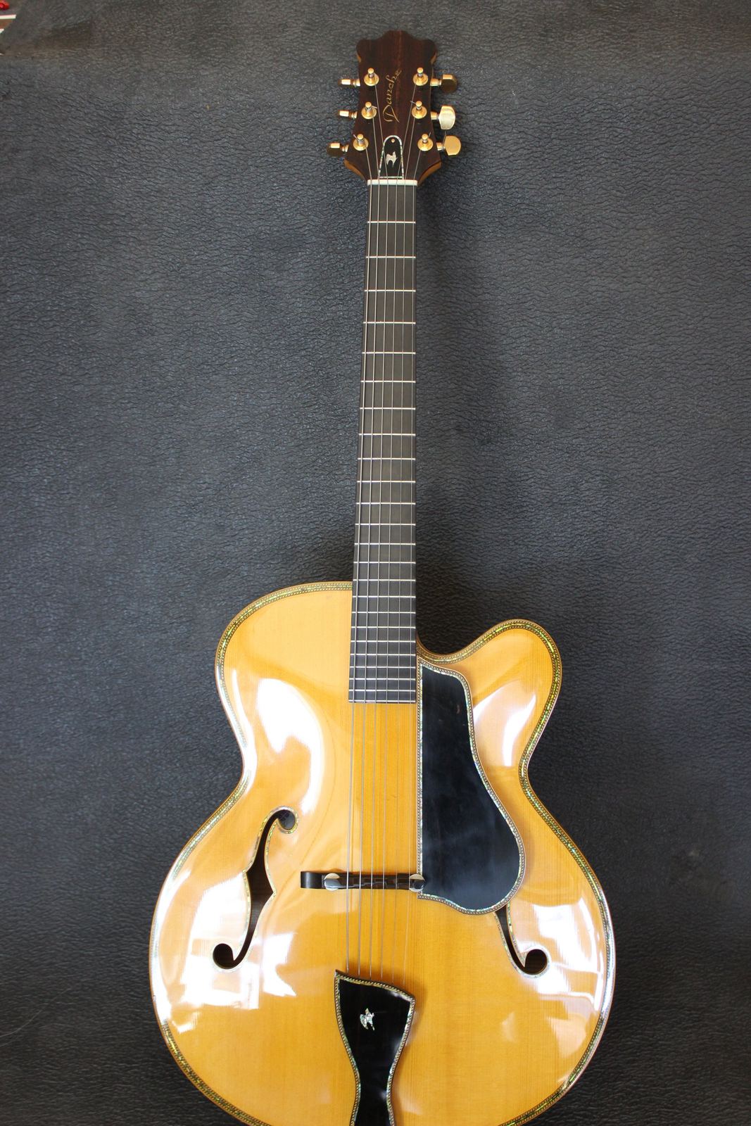 Danche DZ 57 archtop guitar with hand-carved spruce top and tiger maple sides