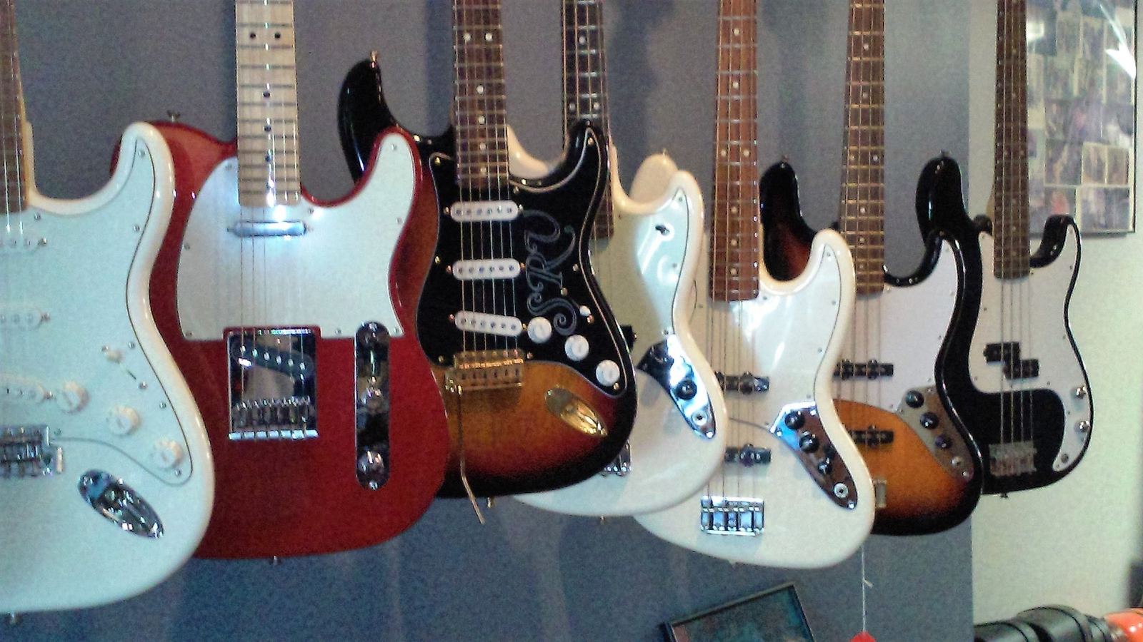 Row of new Fender electric guitars on the shop wall
