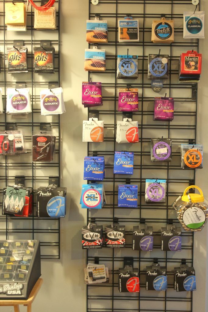 Wall of guitar strings and accessories in the shop